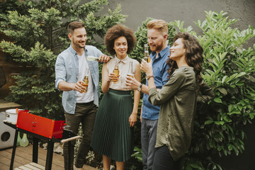 Friends grilling food and enjoying barbecue party