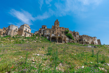Fototapeta premium Craco (Italy) - The evocative ruins and landscapes of the ghost town scattered among the badlands hills of the Basilicata region, beside Matera, destroyed by a landslide and abandoned.