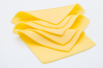 Cheese slices on white background cutout.