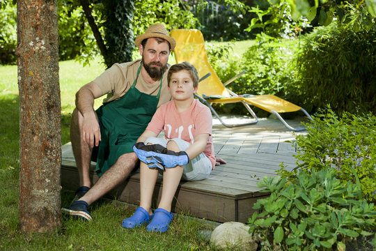 Father and son taking a break in the garden, Munich, Bavaria, Germany