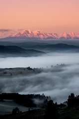 panorama over misty Spisz highland to snowy Tatra mountains in the morning, Poland landscape