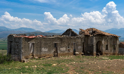 Abandoned house in front of mountain scenery in Albania