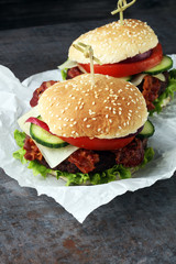 fresh tasty burger on wooden grey background