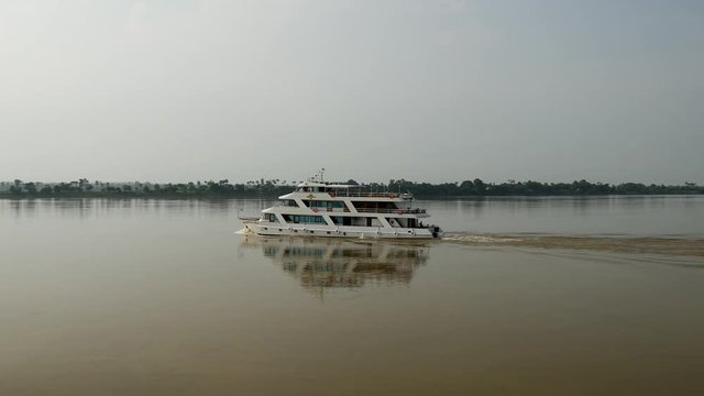 River cruise ship passing by at the Ayeyarwady river, Myanmar, Burma