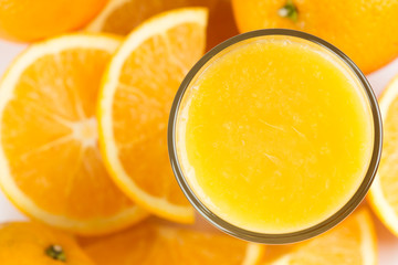Fototapeta na wymiar Glass of orange juice and fresh citrus fruit