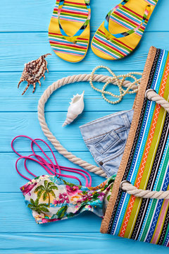 Women beach accessories for sunbath. Things for seaside leisure, cropped image of handbage.