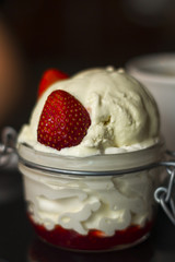 vanilla ice cream with strawberry sauce served in a jar
