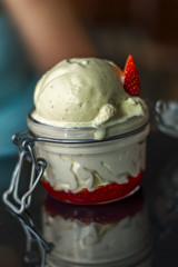 vanilla ice cream with strawberry sauce served in a jar