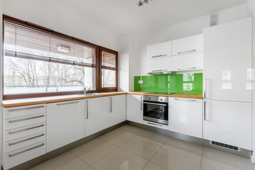 Modern, white kitchen with window