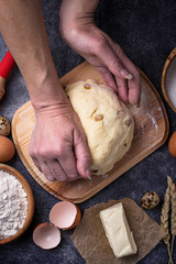 Female hands knead the dough. Backing concept