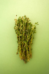 Fresh thyme on a light green textured textured background.