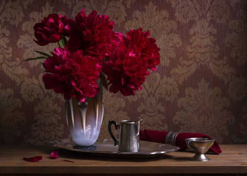 Still life with burgundy peonies in vase