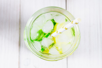 Sassy diet water. Cucumber, lemon, mint lemonade in glasses on white wooden table. Top view. Selective focus