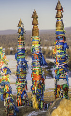 Buddhism symbol - ritual shaman  pillars Serge with colored ribbons in sacred place Cape Burhan on...