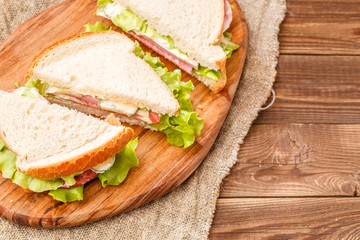 Fresh burgers on wooden board