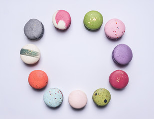 Appetizing cake maccarone lined with a frame on white background, place for text, top view