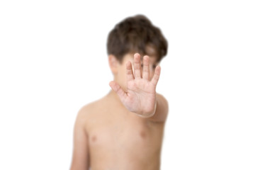 Little kid showing stop gesture with palm in front. Isolated on white