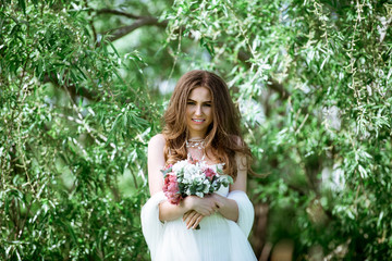 Brunette bride in fashion white wedding dress with makeup