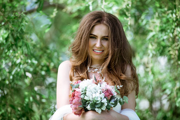 Fototapeta premium Brunette bride in fashion white wedding dress with makeup