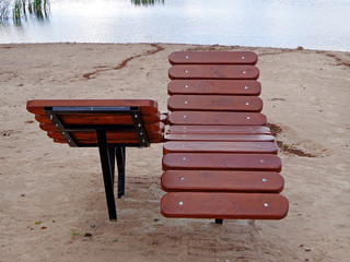 Wooden sunbeds on the shore of the lake