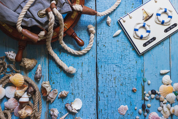 Striped bag and maritime decorations on the wooden background
