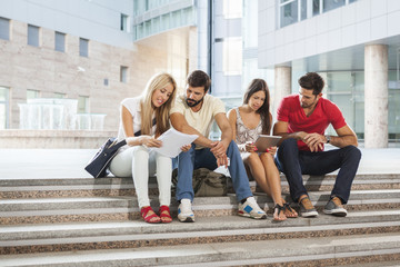 Group of students learning together on campus grounds