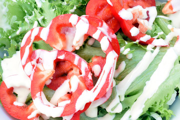 Close up of salad with bell pepper and slad dressing.