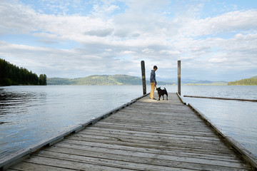 Teenage boy with dog at the lake