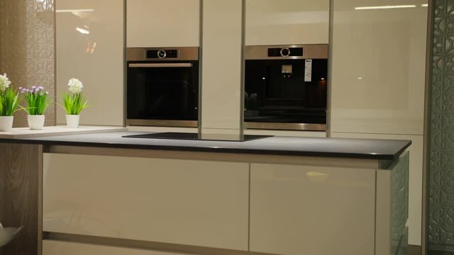 Close up view of white stylish plase for the cooking at the kitchen in the modern style. Camera moving from bottom to top