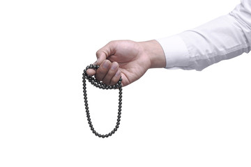 Muslim man praying with prayer beads