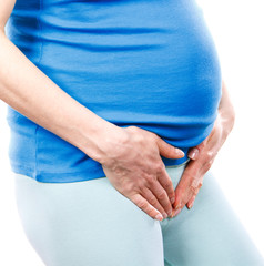 Pregnant woman with hands on her stomach, pregnancy health care and bladder aches