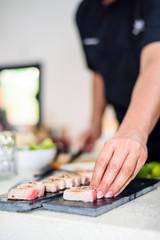 Hand of Chef preparing sushi in the kitchen