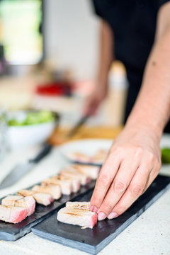 Hand of Chef preparing sushi in the kitchen