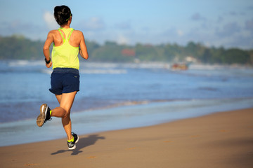 healthy lifestyle young fitness woman running on sunrise beach
