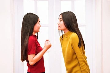 Two  sisters women is arguing and try to make friend later