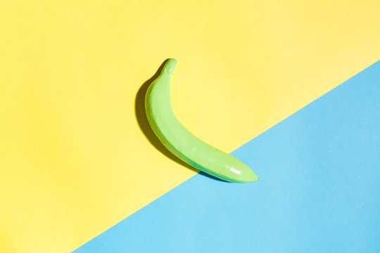 Painted banana on a vibrant split tone background
