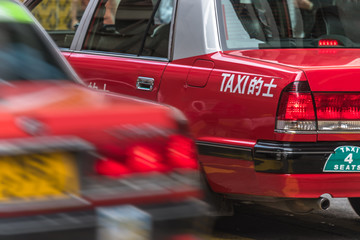 detail shot of red taxi on street.