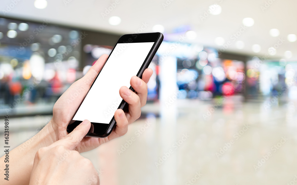 Poster Hand click mobile phone to order with blur department store background bokeh light,White screen mock up template for adding your logo or your text