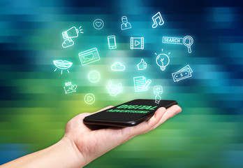Hand holding mobile with Digital Advertising icon feature with blur live concert background,Digital Lifestyle concept
