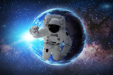 Astronaut in galaxy. Elements of this image furnished by NASA.