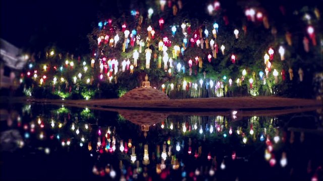 Scenic view of colorful paper lanterns reflecting in the water at the Wat Pan Tao Buddhist temple during the annual Loi Krathong full moon festival