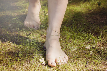 Female barefoot legs walking in nature