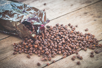 Cup and coffee beans on wooden