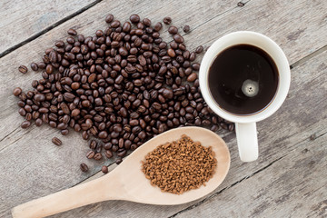 Cup and coffee beans on wooden