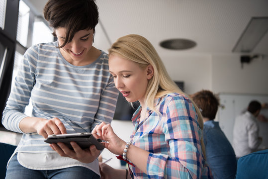 Pretty Businesswomen Using Tablet In Office Building during conference