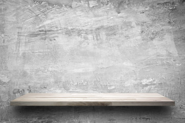 Empty wood shelf on bare concrete wall background © Atstock Productions