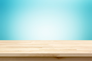 Wood table top on light blue gradient abstract  background