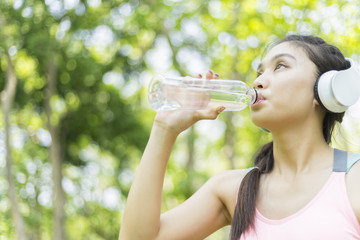 beautiful sport girl drinking water after jogging , sport concept