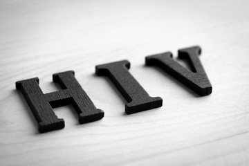 HIV (or Human Immunodeficiency Virus) letters on wood background