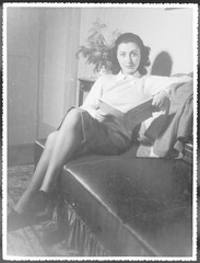 Woman Reads on Sofa. Date: 1940s